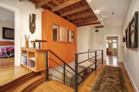 Interior renovation improving flow between levels with updated railing and open transition spaces.