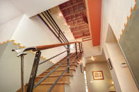 8th St Cottage renovation highlighting vertical space and architectural detail through the stair design.